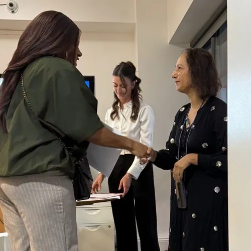 A certificate recipient shakes hands with a presenter at the award ceremony.