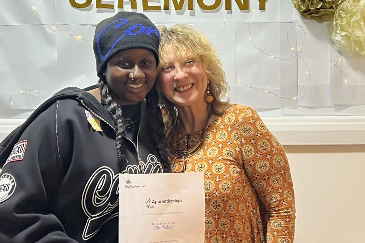 An Early Years Educator Level 3 graduate and her tutor with her certificate at the Apprenticeship Award Ceremony.