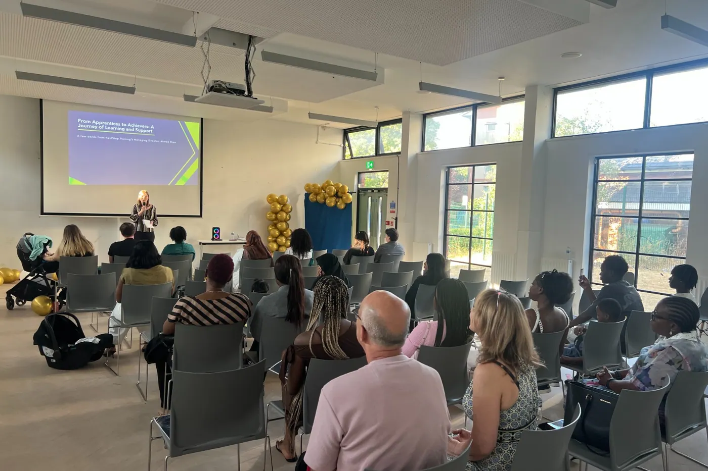 An audience gathered in a hall for the From Apprentices to Achievers event.