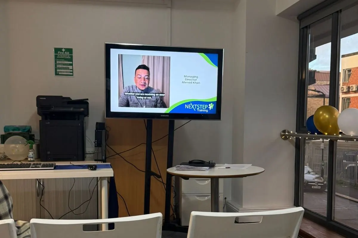 The NextStep office during the Apprenticeship Award Ceremony, with a recorded welcome message on screen.